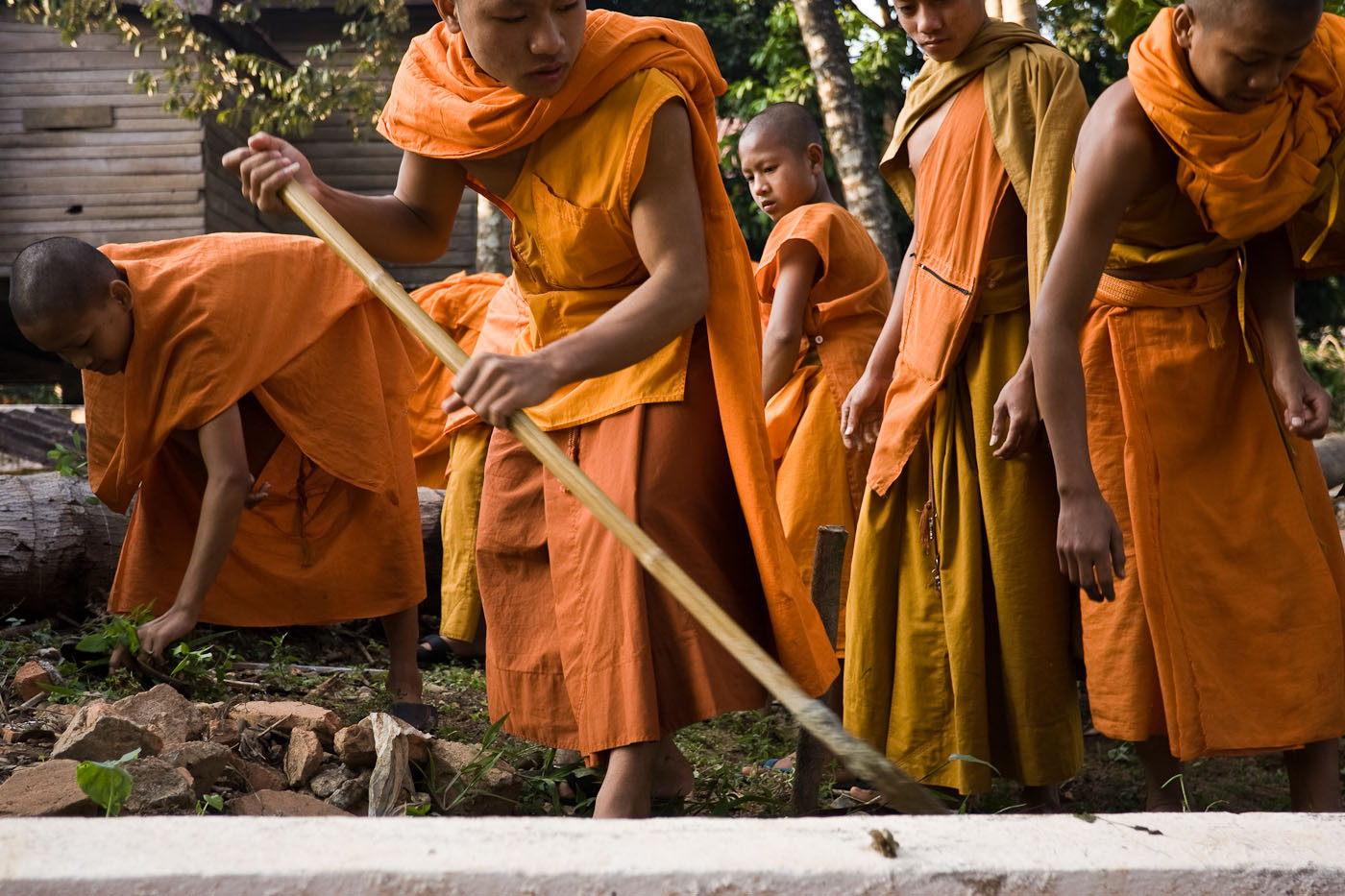 Monks do morning work in Vang Vieng, Laos