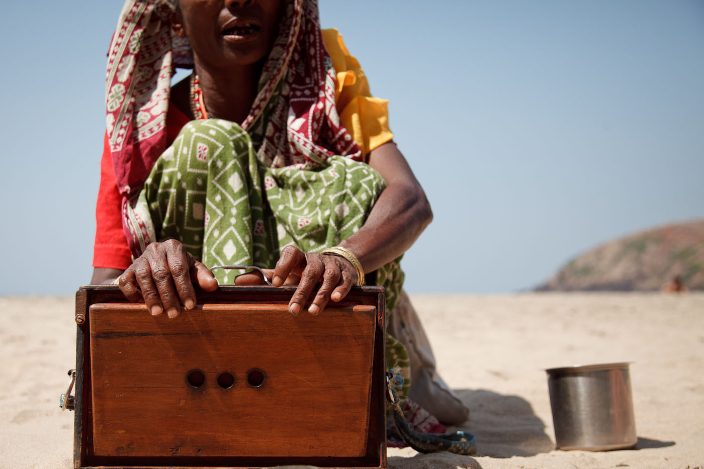 Indian woman singing on the beach for money in Gokarn, India
