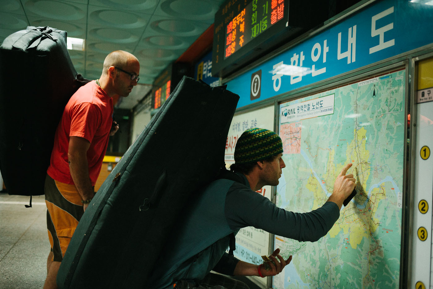 Paul Lammens and Dave McAllister check a subway map in Seoul, South Korea